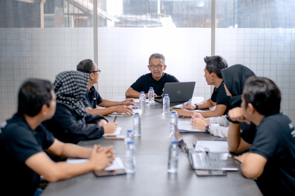 Crafting Captivating Headlines: Your awesome post title goes here Professional team meeting around a conference table in an office setting.